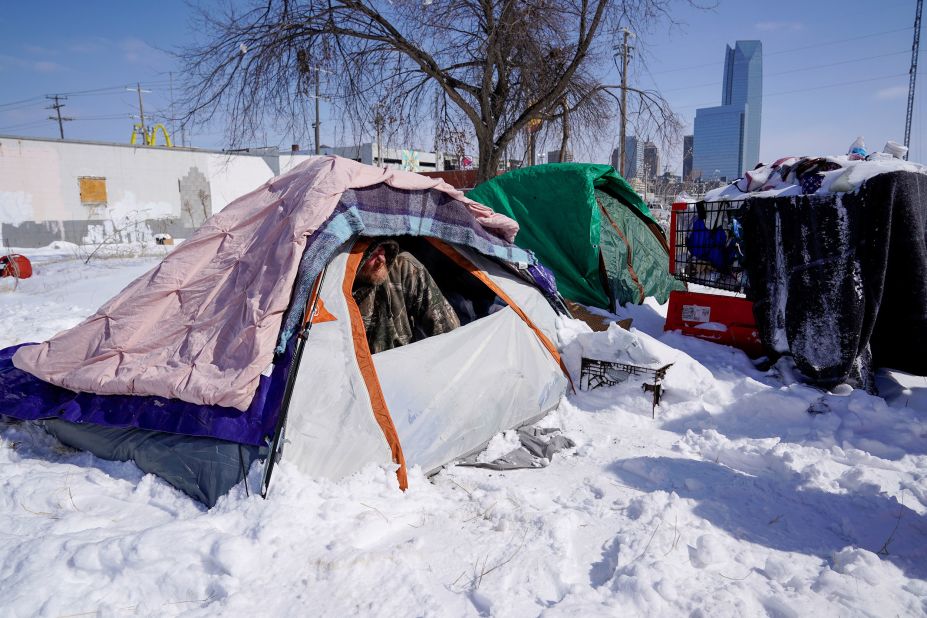 James Derrick, who is homeless, peeks out of his tent in Oklahoma City on Monday. The city had gone a record five days without climbing over 20 degrees, and it wasn't expected to top that temperature until Thursday.