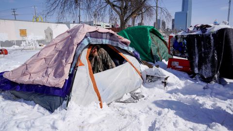 A man experiencing homelessness peeks out of his tent during record-breaking cold weather in Oklahoma City.