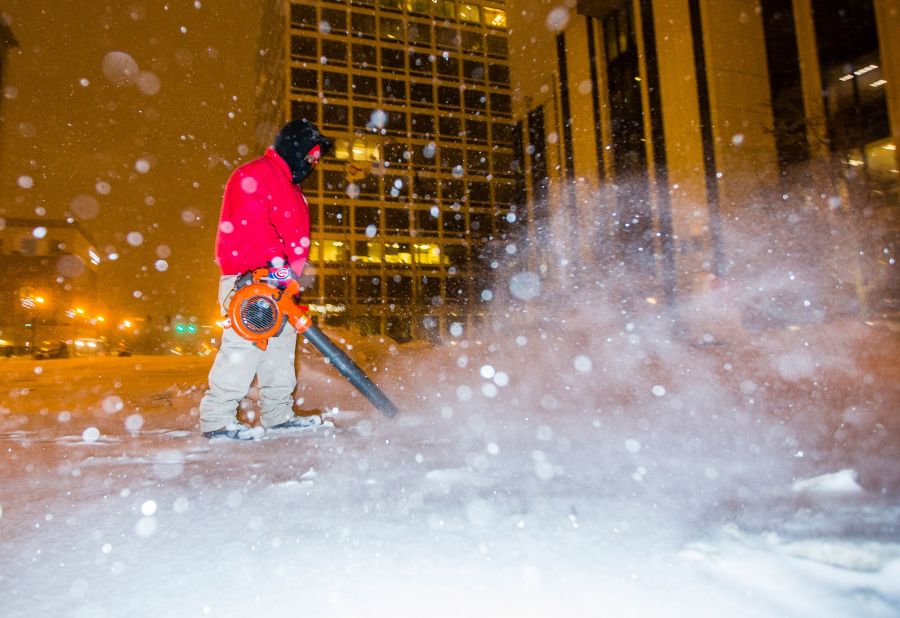 A city employee clears sidewalks in South Bend, Indiana, on Monday.
