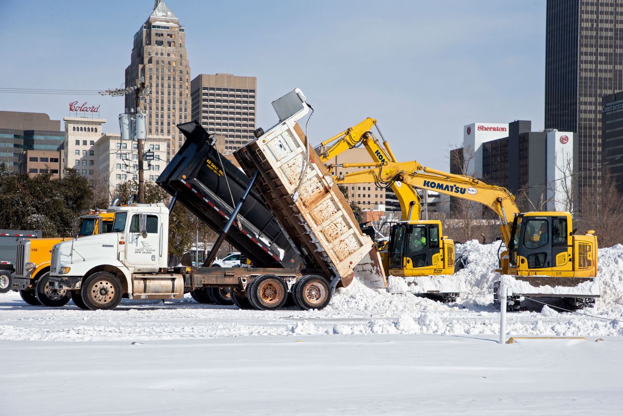Crews unload snow that they removed from city streets in Oklahoma City.