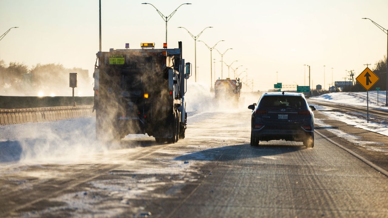 Snow plows clear a lane of I-30, Monday, Feb. 15, 2021, in Dallas. The Nashville Predators and the Dallas Stars NHL hockey game Monday was postponed at the request of Dallas Mayor Eric Johnson due to a shortage of electricity in the region. (AP Photo/Brandon Wade)