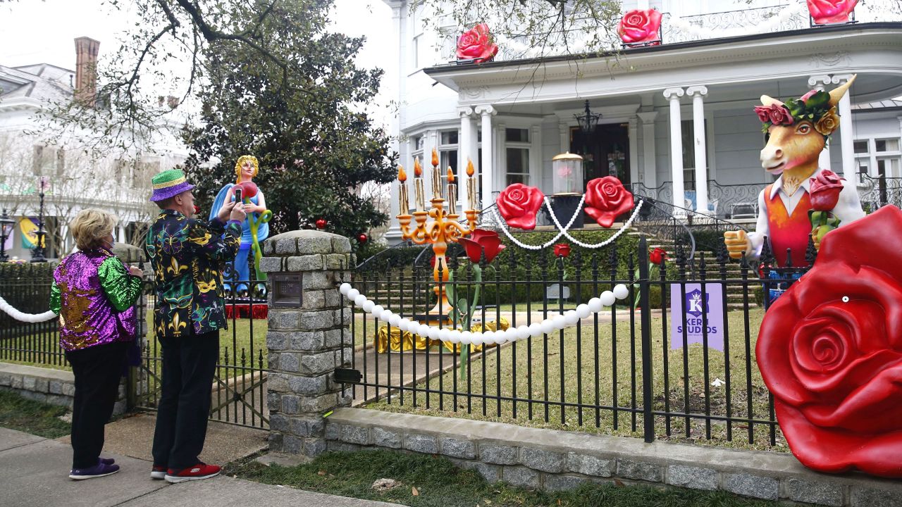 People take pictures of house decorations on February 14, 2021. House "floats" replaced parades this year.