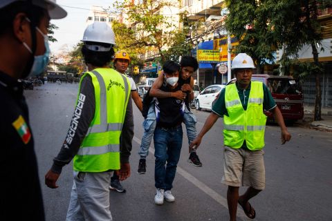 Medics clear the way as an injured protester is carried away for treatment in Mandalay, Myanmar, on February 15.