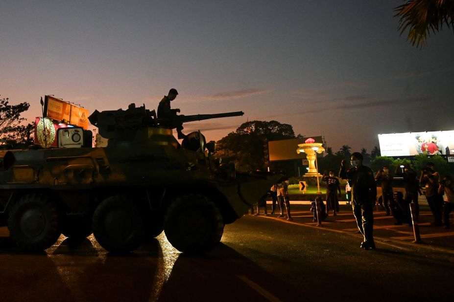 People gather around an armored vehicle in Yangon on February 14.