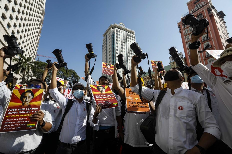 Members of the Myanmar Photographers Association hold up their cameras as they call for Suu Kyi's release on February 13.