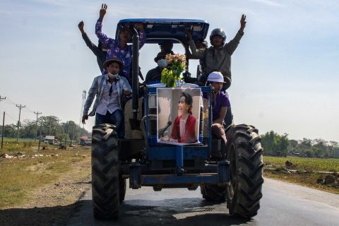 Farmers ride a tractor with a Suu Kyi poster during a demonstration in Thongwa on February 12.