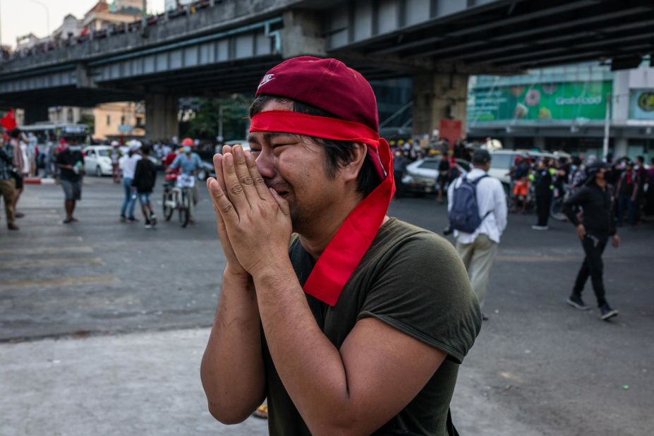 A protester pleads for police to refrain from using tear gas against demonstrators in Yangon on February 9.