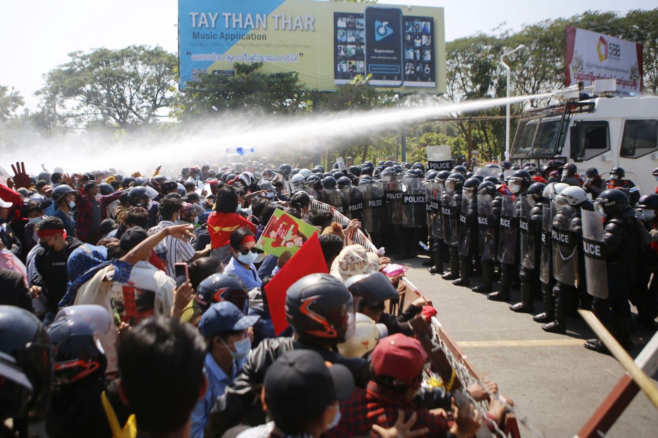 Police fire water cannons at protesters in Naypyidaw on February 9.