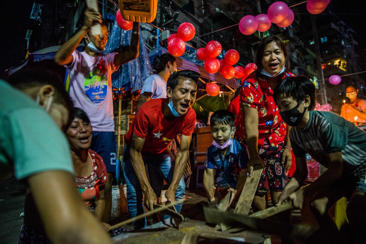 Yangon residents bang objects to show support for Suu Kyi and her party on February 5.