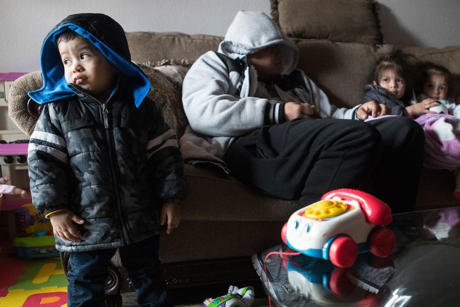 Eithan Colindres wears a winter coat inside after his family's apartment lost power in Houston on Monday.