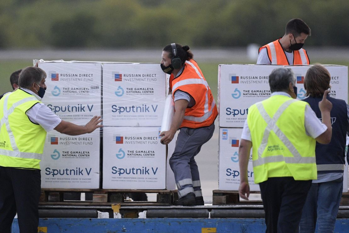 Airport workers unload shipping containers with Sputnik V vaccine doses against COVID-19, at the Ezeiza International Airport in Buenos Aires, on February 12, 2021.