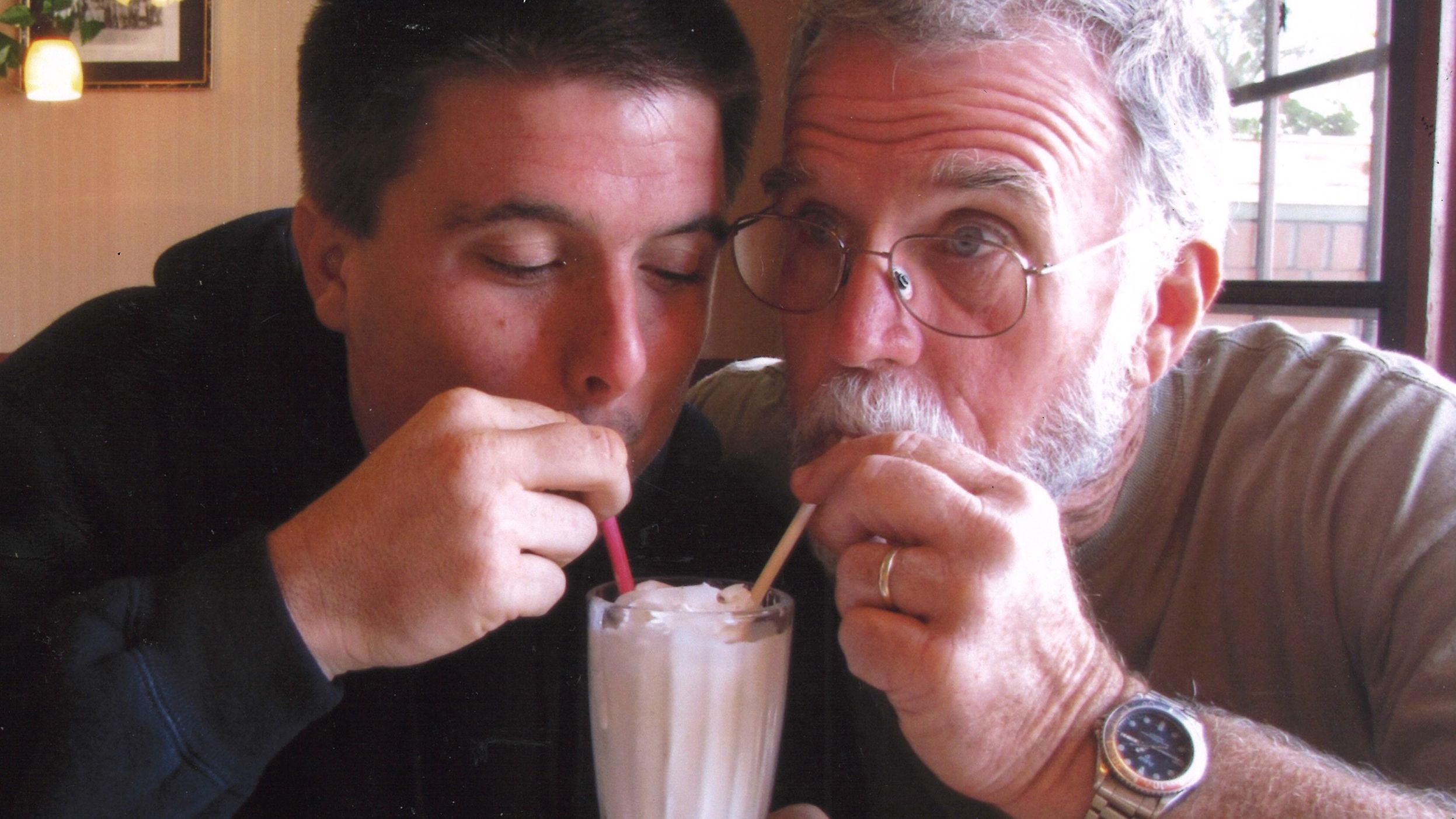Sean and Pat share a milkshake in 2015.
