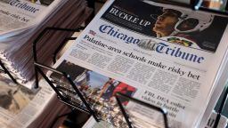 FILE - In this Monday, April 25, 2016, file photo, Chicago Tribune and other newspapers are displayed at Chicago's O'Hare International Airport.  Hedge fund Alden, Tribune's largest shareholder, has offered to buy the rest of the newspaper publisher, Thursday, Dec. 31, 2020,  at a price that values it at $520.6 million.   (AP Photo/Kiichiro Sato, File)