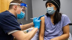 Edith Arangoitia, 46, (who came as a companion to her elderly mother) is vaccinated with the Pfizer-BioNTech Covid-19 vaccine by Doctor Galen Harnden at La Colaborativa in Chelsea, Massachusetts on February 16, 2021. - Chelsea, with a population of close to 40,000 people, is one of the hardest hit cities in the United States by Covid-19 with close to 8,000 infected people and over 200 deaths from the virus.  The community is made up of close to 70 percent Latino or Hispanic people and also retains a large undocumented population.  East Boston Neighborhood Health Center is working with La Colaborativa to vaccinate any person in the community that wants to be vaccinated and is working to get the message out in multiple languages.  Signs are outside the building in Spanish and English.  La Colaborativa is all ready an established institution in the community for helping and empowering immigrants in the city. (Photo by Joseph Prezioso / AFP) (Photo by JOSEPH PREZIOSO/AFP via Getty Images)
