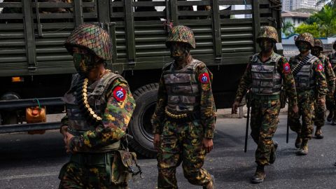 Myanmar military soldiers from the 77th Light Infantry Division stand guard armoured vehicles on February 15, 2021 near the Central Bank in Yangon, Myanmar. 