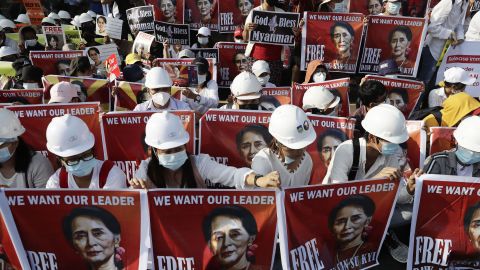 Civil engineers hold placards calling for the release of State Counselor Aung San Suu Kyi during a protest against the Myanmar military coup, outside the US Embassy in Yangon on 17 February 2021.