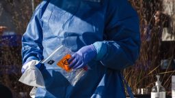 A healthcare worker from the Medical University of South Carolina holds a bio-hazard bag for a Covid-19 test at a site in a parking lot between Edmund's Oast and Butcher & Bee restaurants in Charleston, South Carolina, U.S., on Wednesday, Jan. 13, 2021. With Covid-19 cases rising and straining local hospitals, the city of Charleston moved to a heightened level of pandemic response Monday that further restricts public gatherings and access to city offices, the Post and Courier reports. 