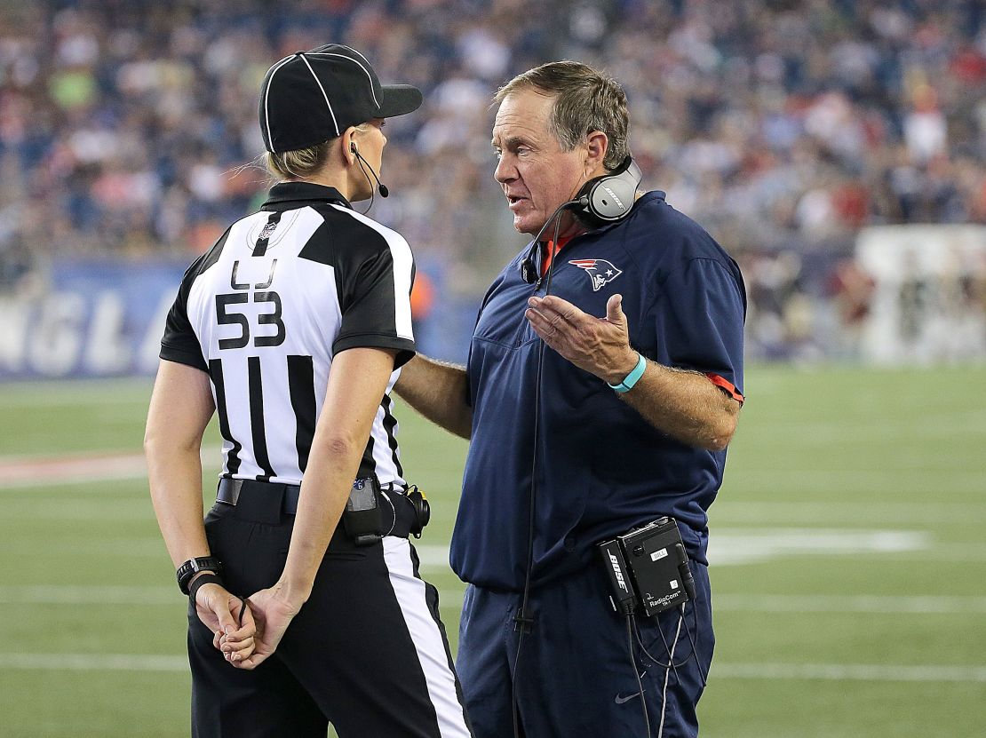 Bill Belichick, coach of the New England Patriots, and Sarah Thomas exchange words on the sidelines.
