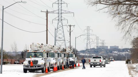 Electric service trucks line up in Fort Worth, Texas, after historic cold, snow and ice knocked out power to millions across the state.