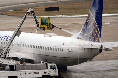 A United Airlines jet is de-iced at the George Bush International Airport in Houston.