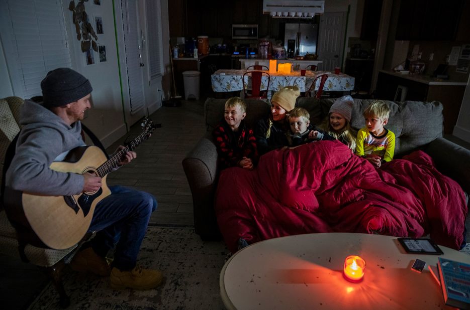 Brett Archibad entertains his family as they try to stay warm in their home in Pflugerville, Texas, on Tuesday.