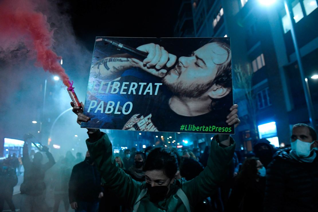 Protesters march with a picture of Hasel reading "Freedom to Pablo."