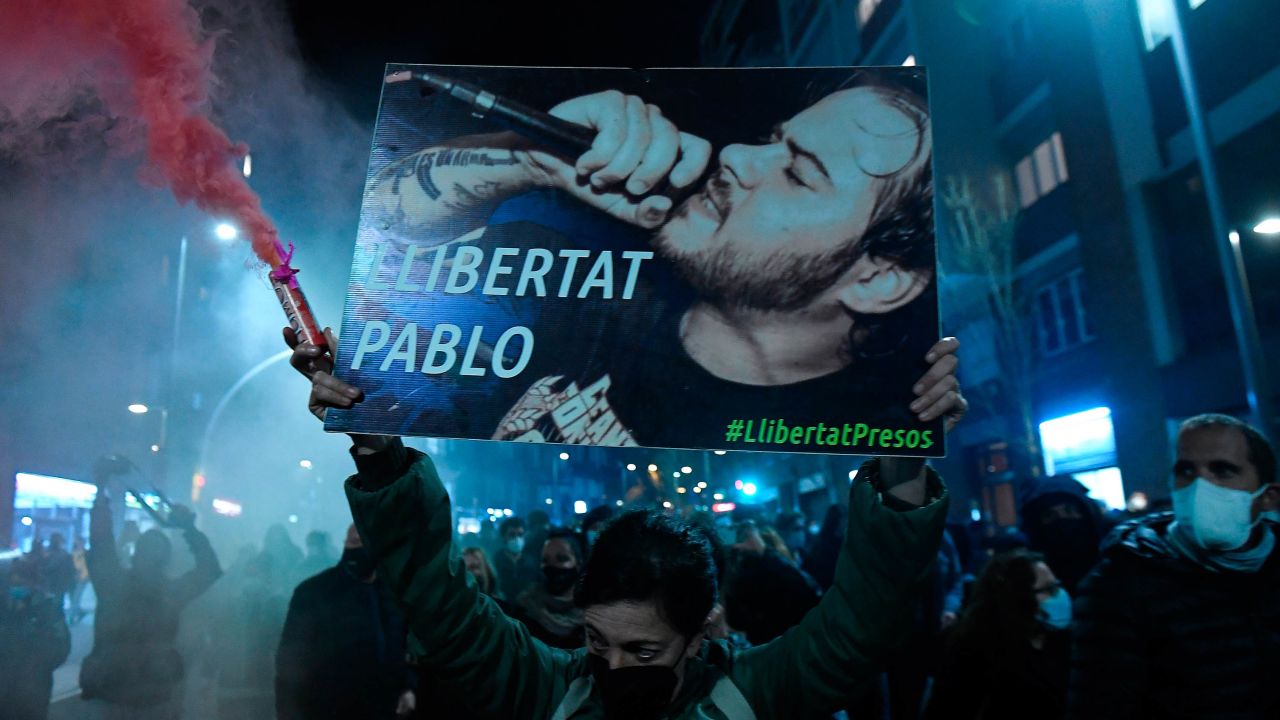 Protesters march with a picture of Hasel reading "Freedom to Pablo."