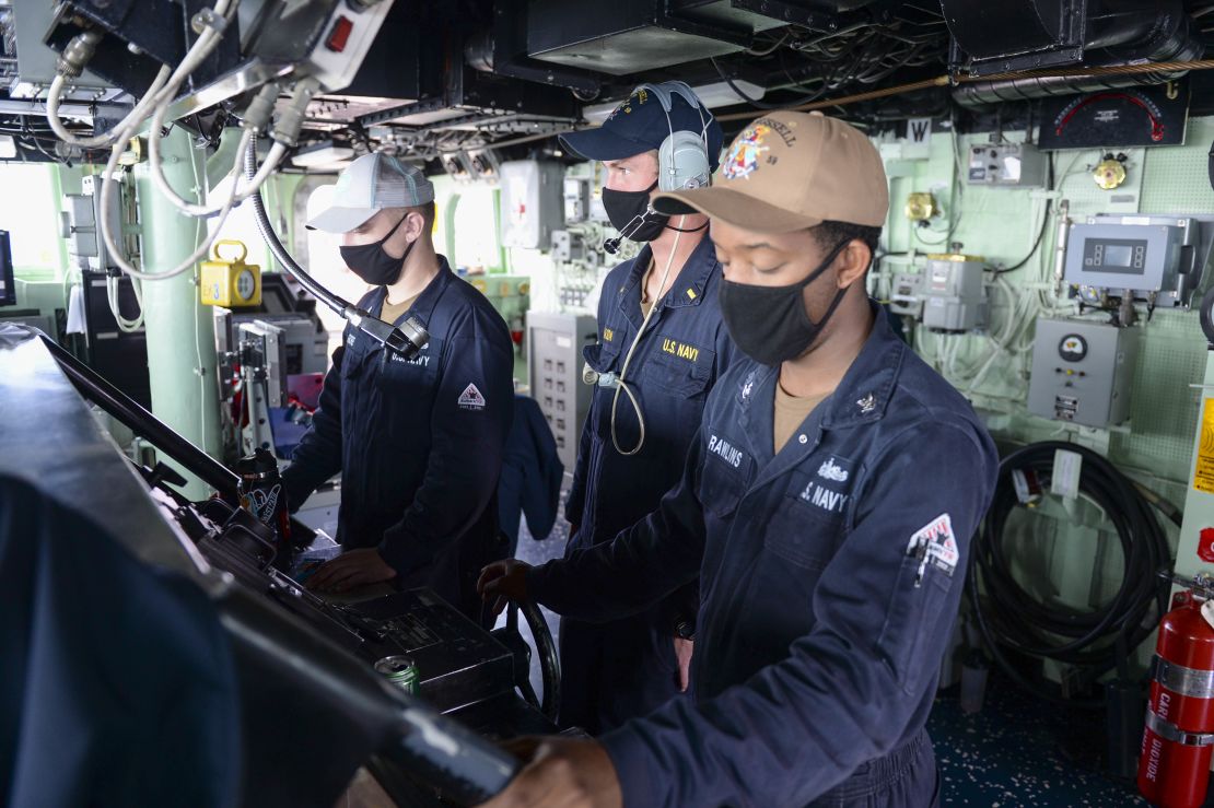 US sailors stand watch at the helm on the bridge as the guided-missile destroyer USS Russell. The warship is deployed to the US 7th Fleet area of operations in support of a free and open Indo-Pacific.