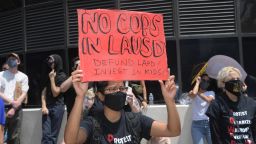 Demonstrators hold signs during a protest to demand the defunding of the Los Angeles school district police outside of the school board headquarters Tuesday, June 23, 2020, in Los Angeles. ((Kirby Lee via AP)