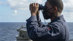 PACIFIC OCEAN (Feb. 17, 2021) U.S. Navy Ensign Ryan Simpson, from Baltimore, looks through a pair of binoculars on the bridge wing as the guided-missile destroyer USS Russell (DDG 59) conducts routine underway operations. Russell is forward-deployed to the U.S. 7th Fleet area of operations in support of a free and open Indo-Pacific. (U.S. Navy photo by Mass Communication Specialist 3rd Class Wade Costin)