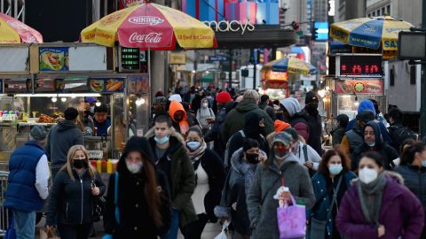 Masked pedestrians walk through New York City in November 2020.