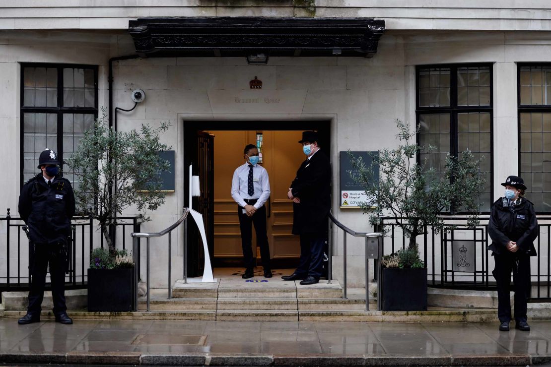Police stand guard outisde the entrance to King Edward VII hospital in central London where Prince Philip was admitted on Tuesday.