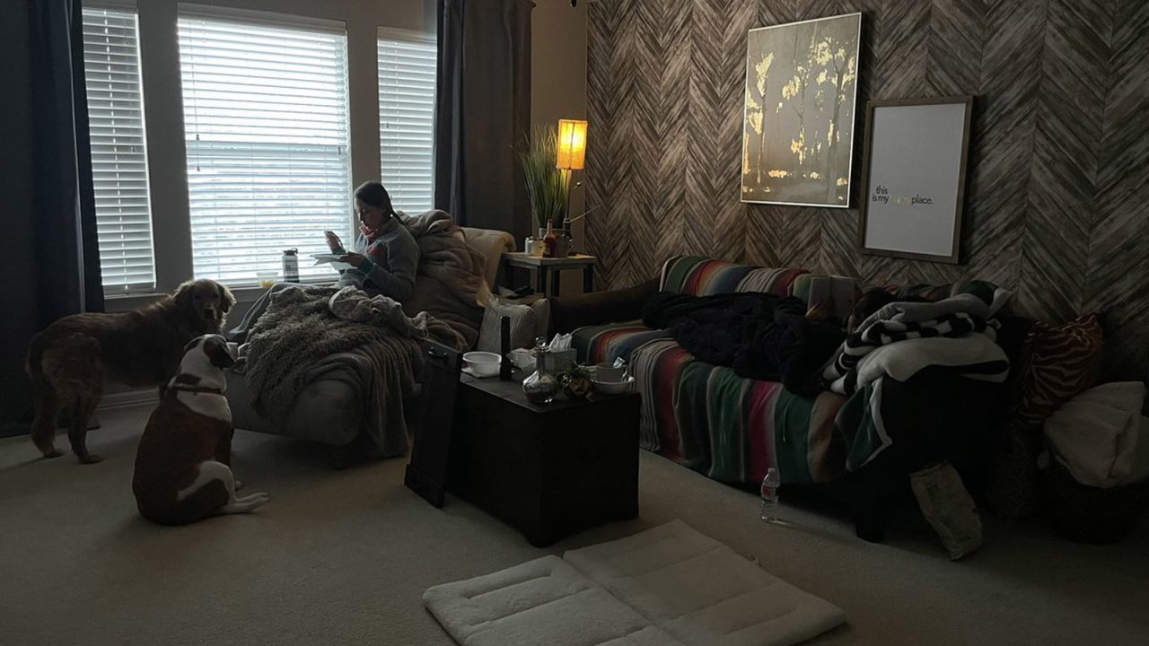 Gina Escajeda (left) sits in a room with Starla Everett (on the couch, right), who welcomed Gina and Adrian Escajeda into her home while their power was out. 