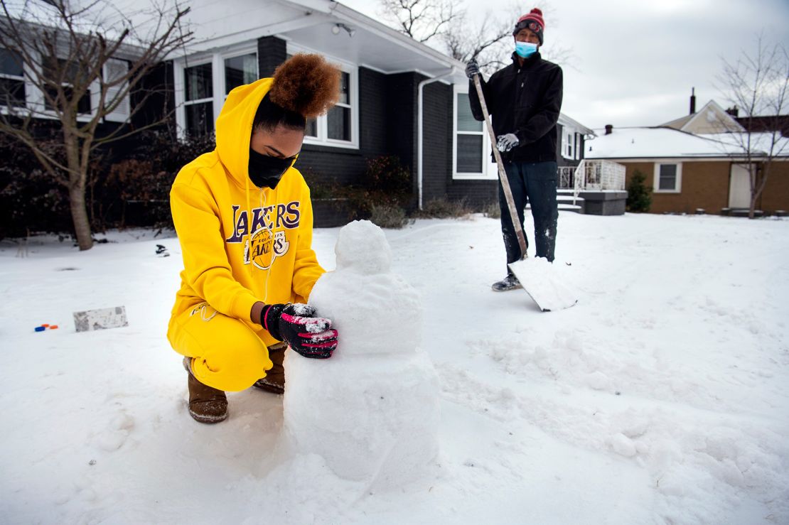 Madison Horton 15, builds a snowman in her front yard of her home in Nashville, Tennessee.