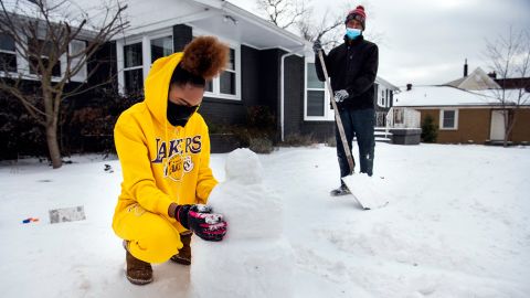 Madison Horton 15, builds a snowman in her front yard of her home in Nashville, Tennessee.