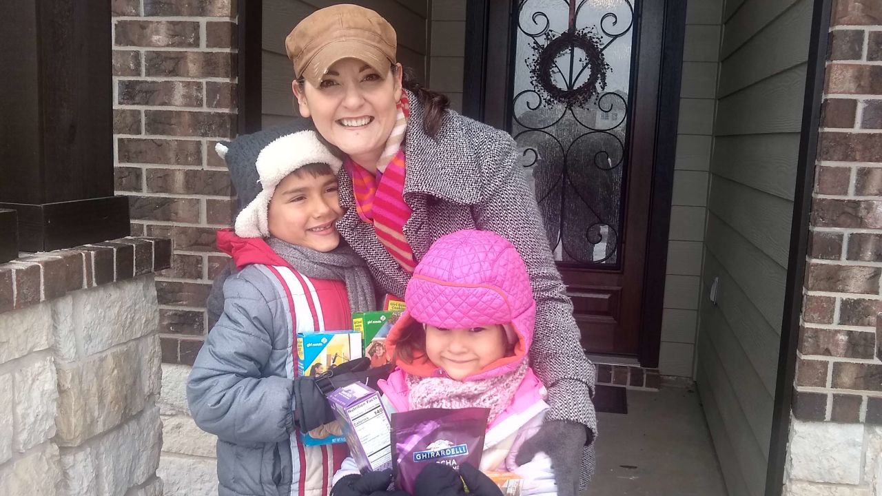 Karen Rambo-Hernandez and her children, Clark (left) and Clara, were excited to find boxes of Girl Scout cookies and hot cocoa mix on their doorstep, left by a kind neighbor. 