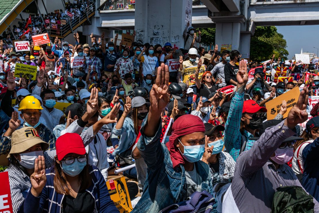 Protesters make three-fingered salutes and chant slogans during an anti-coup protest at Sule Square on February 17, 2021 in Yangon, Myanmar. 