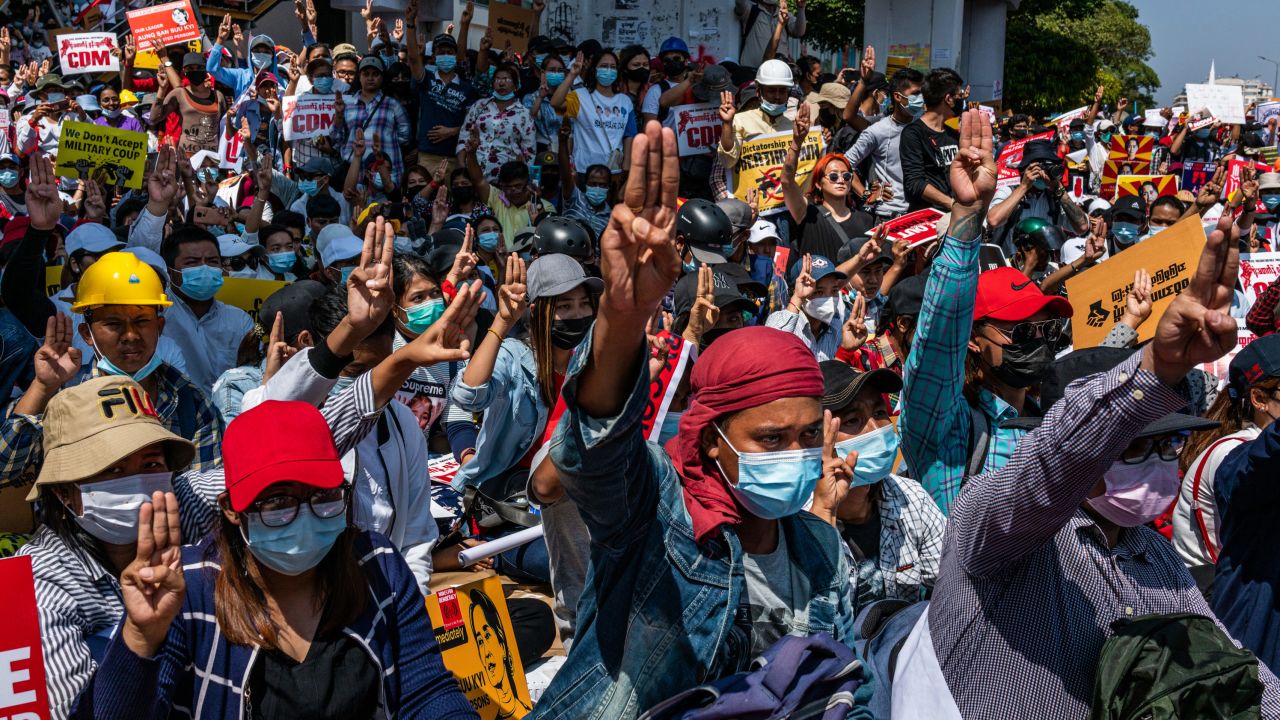 Protesters make three-fingered salutes and chant slogans during an anti-coup protest at Sule Square on February 17, 2021 in Yangon, Myanmar.