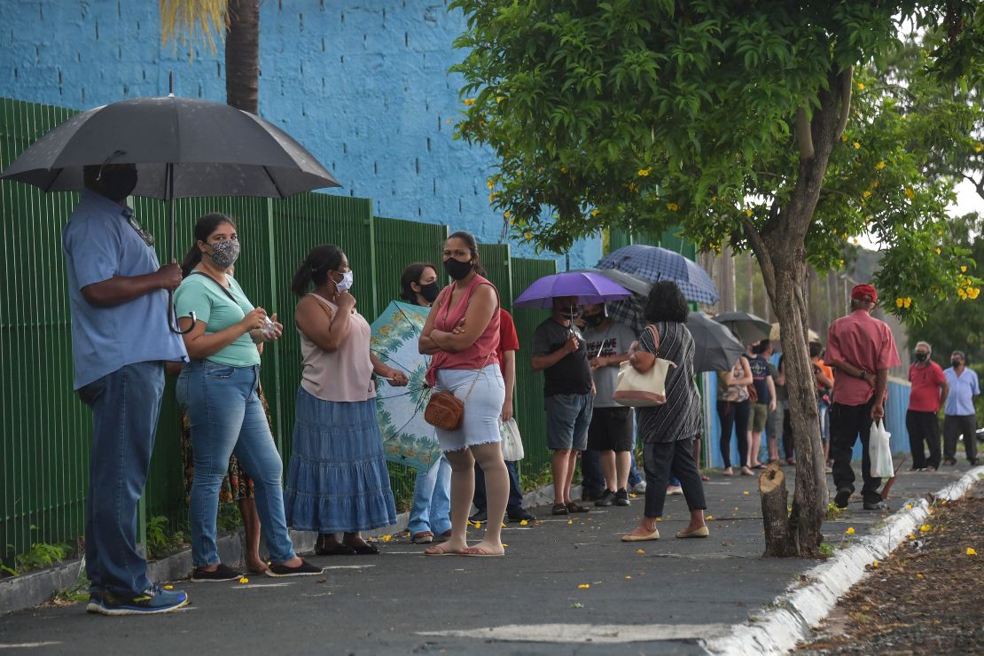 Residents line up to receive the Coronavac vaccine against COVID-19, in Serrana, about 323 km from Sao Paulo, Brazil, on February 17, 2021.