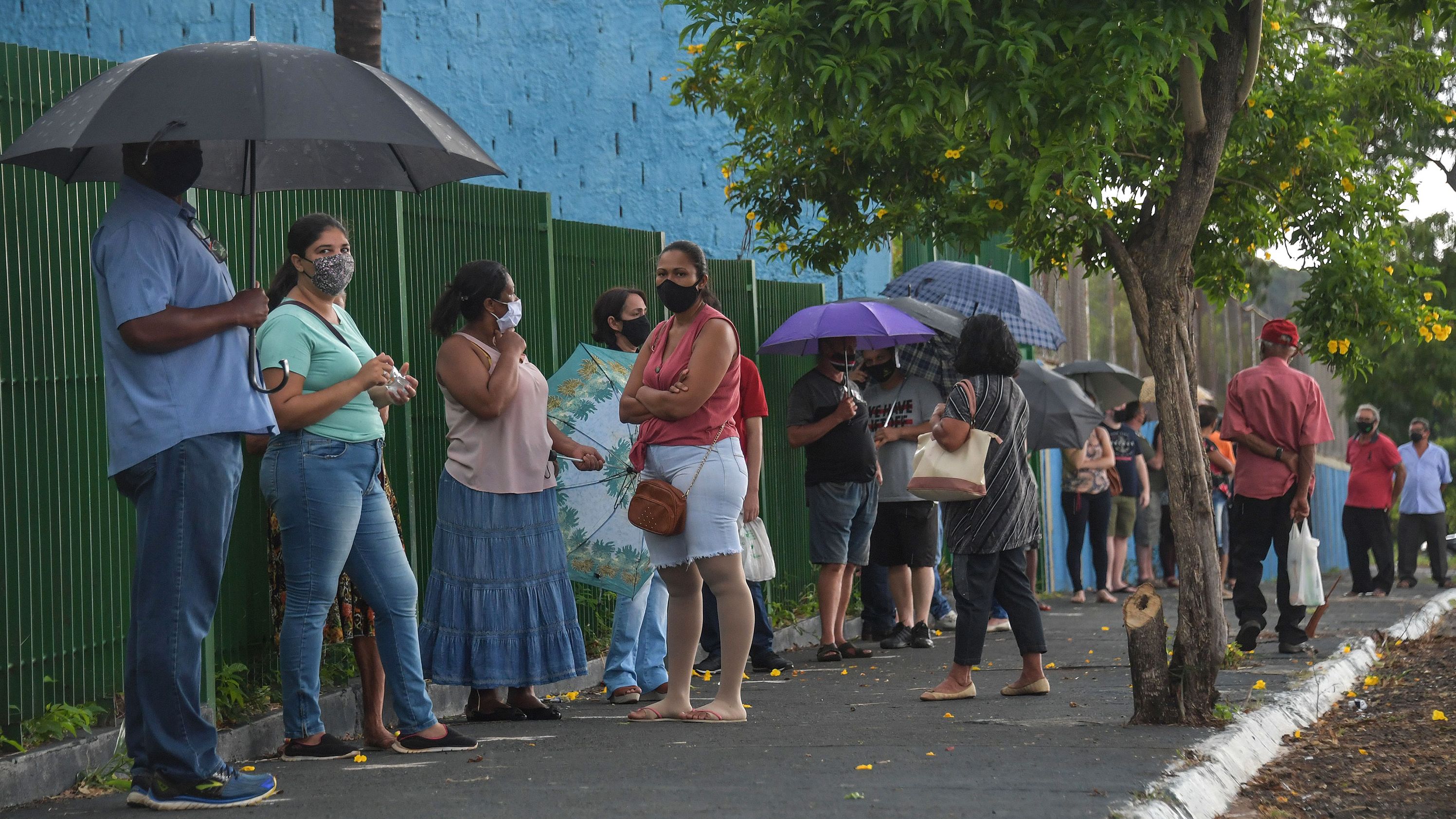Residents line up to receive the Coronavac vaccine against COVID-19, in Serrana, about 323 km from Sao Paulo, Brazil, on February 17, 2021.