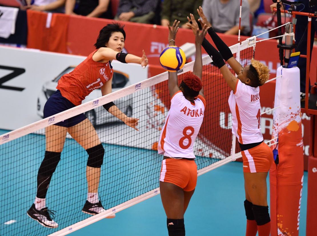 South Korea's Lee Da-yeong, left, spikes the ball over Kenya's Trizah Atuka, center, and Jane Wacu Wairimu, right, during a match of the FIVB Women's World Cup volleyball between South Korea and Kenya in Osaka on September 27, 2019.