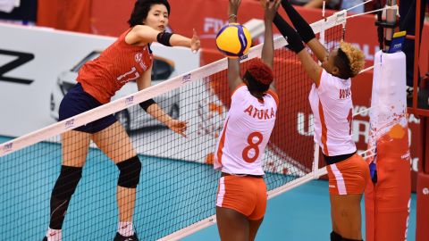 South Korea's Lee Da-yeong, left, spikes the ball over Kenya's Trizah Atuka, center, and Jane Wacu Wairimu, right, during a match of the FIVB Women's World Cup volleyball between South Korea and Kenya in Osaka on September 27, 2019.