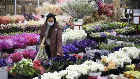 A customer wears a face mask while shopping for flowers on February 12, 2021 in Los Angeles, California
