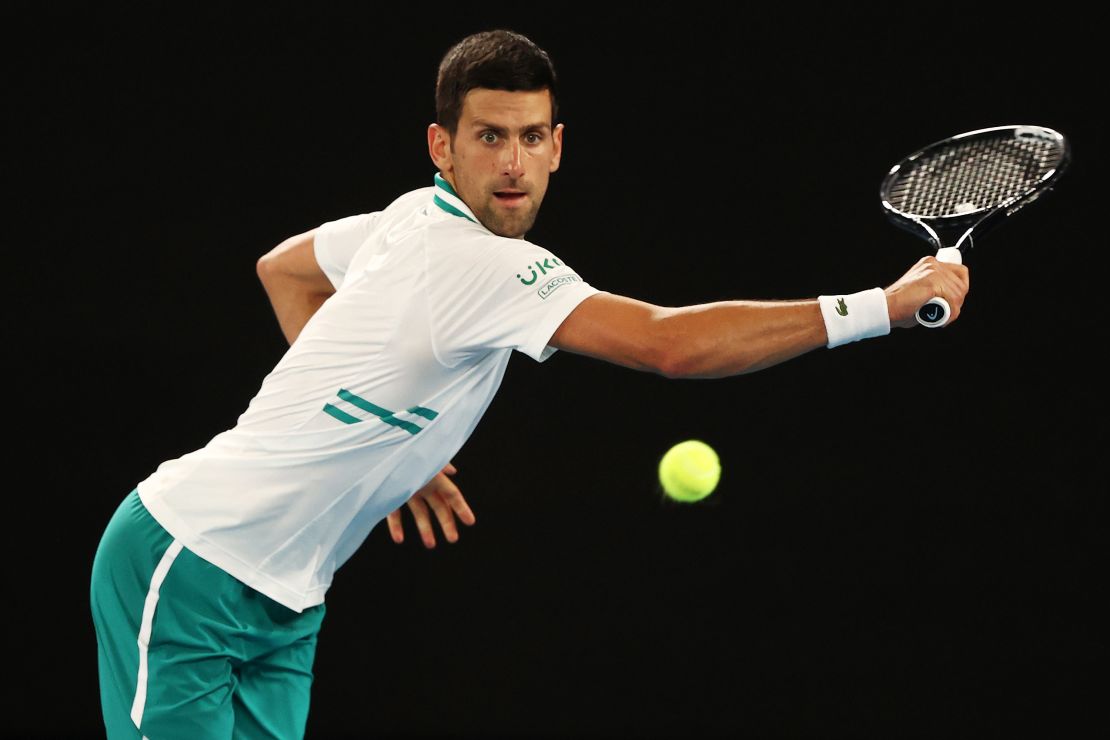 Djokovic plays a backhand against Karatsev.