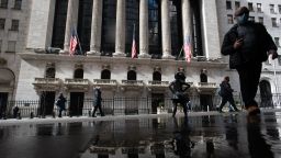 People walk by the New York Stock Exchange (NYSE) in the Financial District in Manhattan in New York City.