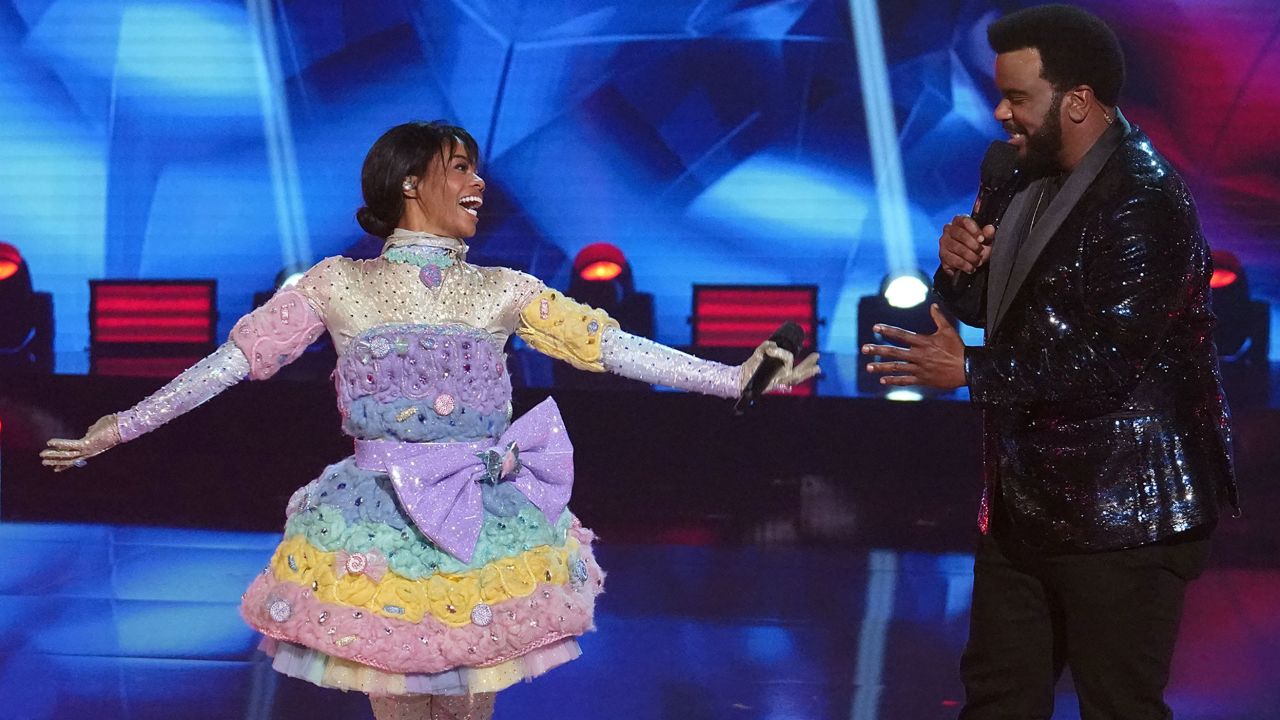 THE MASKED SINGER: L-R: Gabby Douglas and host Craig Robinson in the "Road to the Finals -- Final Clues to the Mask!/ The Finale -- One Last Mask!" special two-hour season finale of THE MASKED DANCER airing Wednesday, Feb. 17 (8:00-10:00 PM ET/PT) on FOX.  © 2021 FOX Media LLC.