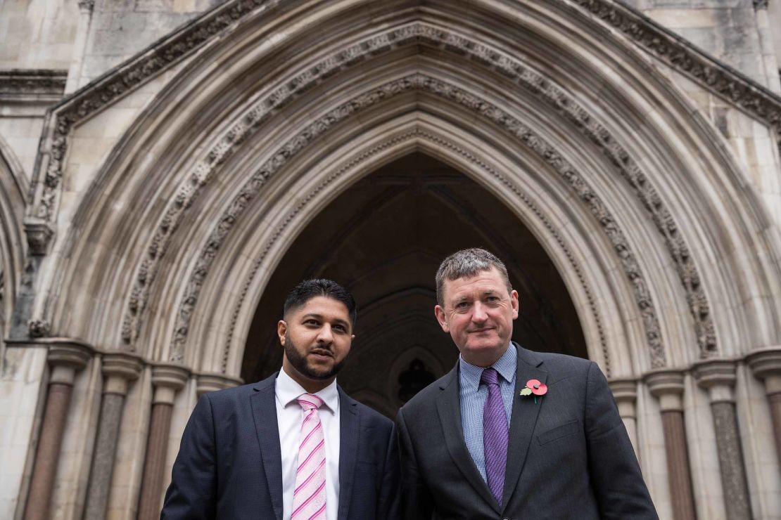 Uber drivers Yaseen Aslam, left, and James Farrar, pose outside the Court of Appeal in London in 2018.