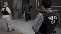 U.S. Immigration and Customs Enforcement (ICE) agents look on as an undocumented man is received by a Mexican immigration agent at a removal gate of the U.S.-Mexico border in San Diego, California, U.S., on Thursday, Feb. 26, 2015. The U.S. Department of Homeland Security is nearing a partial shutdown as the agency's funding is set to expire Friday -- something Senate Majority Leader Mitch McConnell had said wouldn't happen on his watch. Photographer: David Maung/Bloomberg via Getty Images