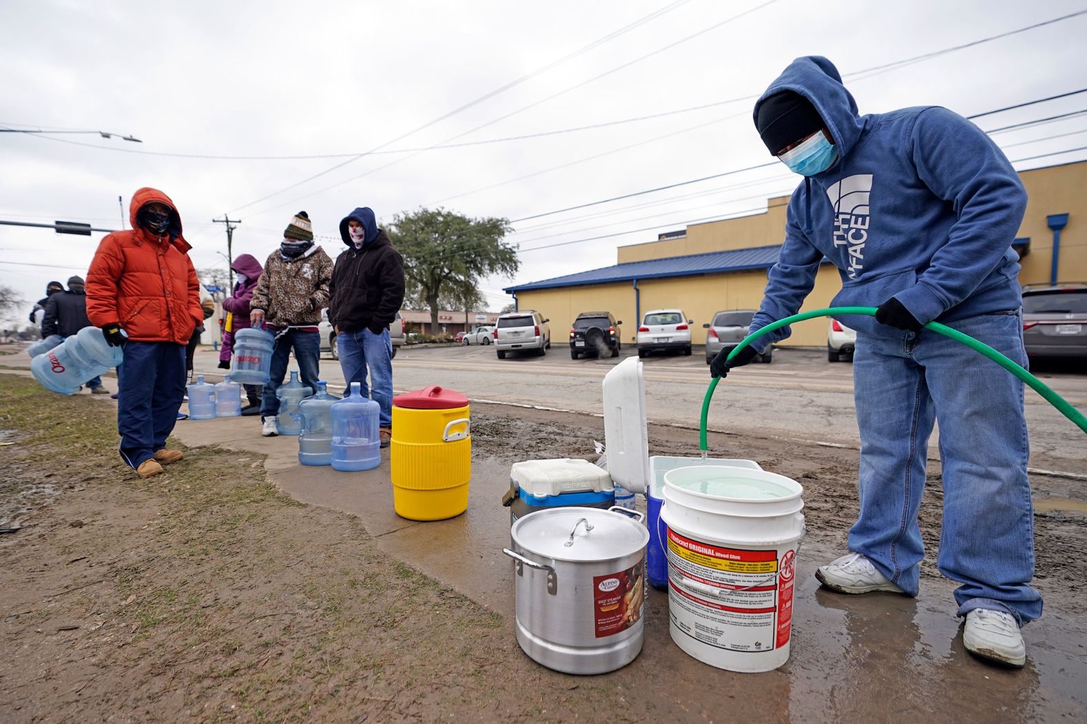 Jose Blanco fills a cooler with water from a public park spigot in Houston on Thursday. Houston and several surrounding cities were under a boil-water notice.