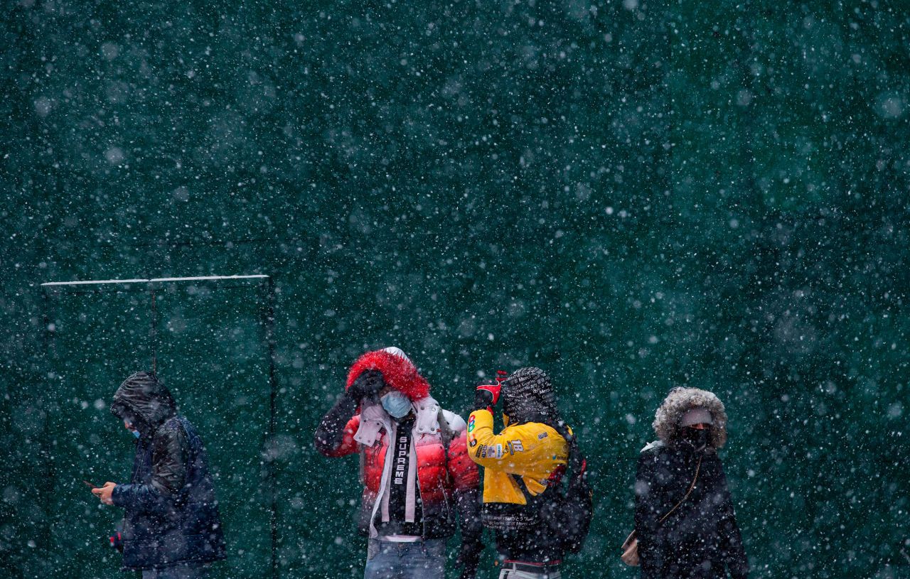 Snow falls in New York's Times Square on Thursday.